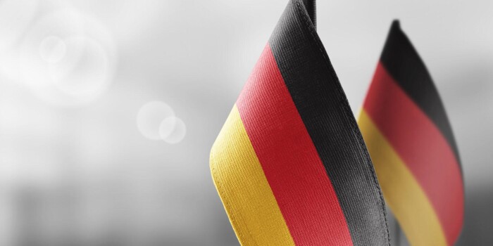small-national-flags-germany-light-blurry-wall-2048x932